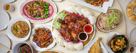 A food spread depicting Phoenix Inn Chinese Cuisine menu items.