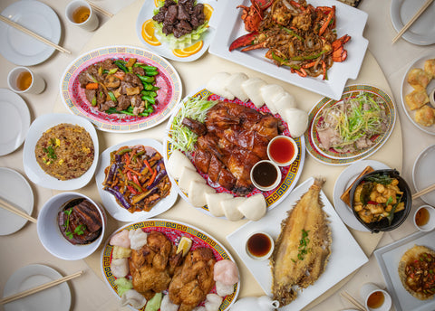 A food spread depicting Phoenix Inn Chinese Cuisine menu items.