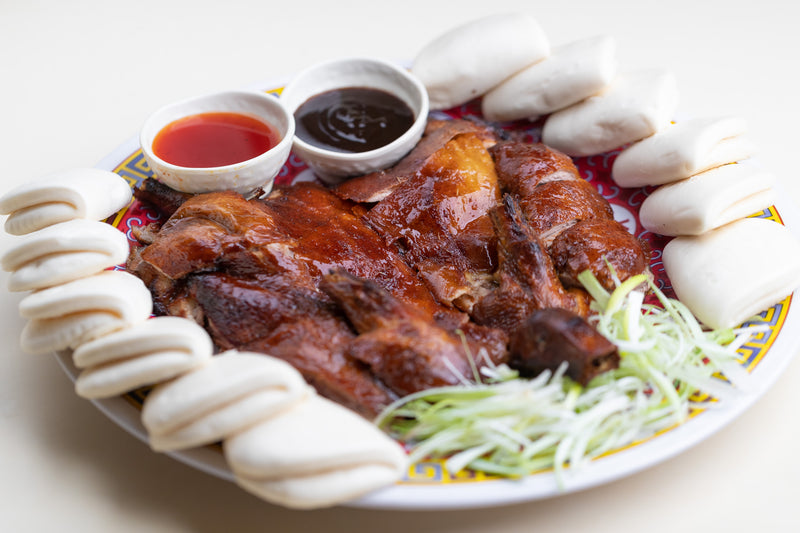 Phoenix Inn Chinese Cuisine duck with two sauce cups on a large plate.